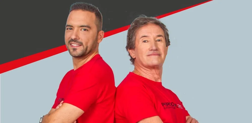 Two P20 trainers in red Personal20 shirts standing back to back